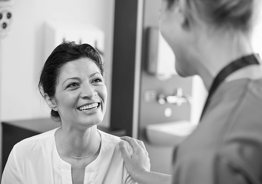 A patient smiling alongside the dentist.